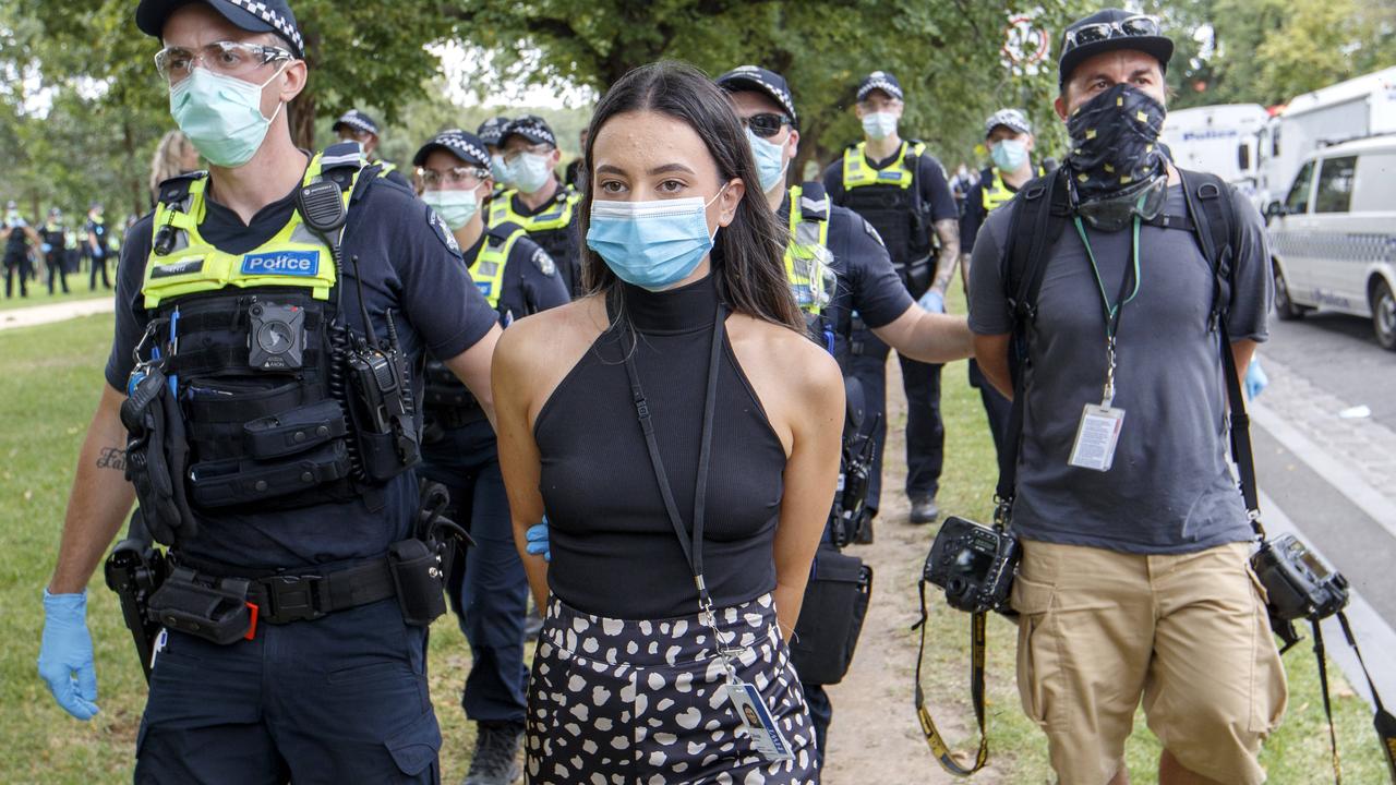 Herald Sun reporter Olivia Jenkins and photographer Jake Nowakowski are arrested at a protest at Fawkner Park in Melbourne. Picture: NCA NewsWire/David Geraghty