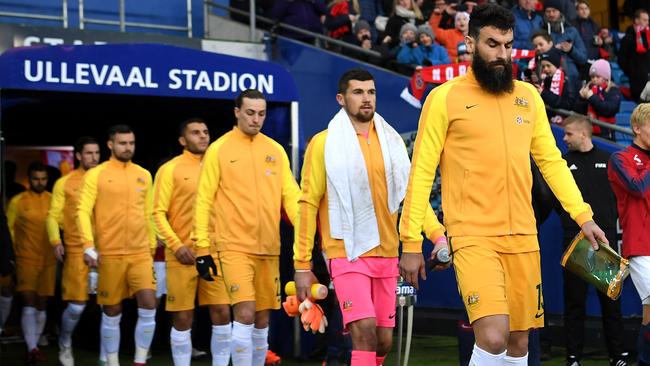 Mile Jedinak leads out the Socceroos.