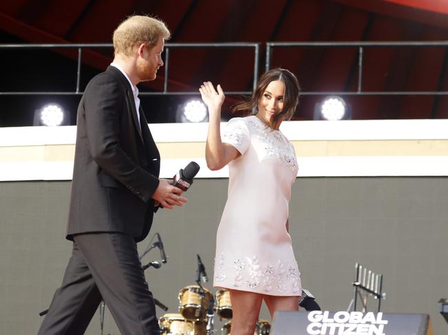 The Duchess of Sussex waves to the crowd as she walks onstage. Picture: Getty Images