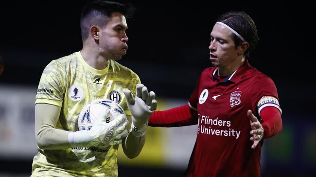 Northcote City goalkeeper Brandon Cuminao and Adelaide United skipper Craig Goodwin. Picture: Daniel Pockett