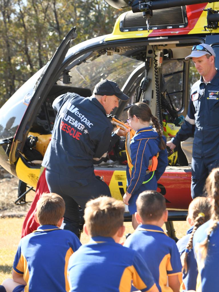 SLSQ Westpac helicopter demonstrate a rescue with Mount Whitestone State School student Eliza Sutton. PHOTO: ALI KUCHEL