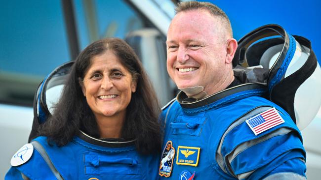 (FILES) NASA astronauts Butch Wilmore (R) and Suni Williams, wearing Boeing spacesuits, depart the Neil A. Armstrong Operations and Checkout Building at Kennedy Space Center for Launch Complex 41 at Cape Canaveral Space Force Station in Florida to board the Boeing CST-100 Starliner spacecraft for the Crew Flight Test launch , on June 5, 2024. Two astronauts stranded in space may sound like the start to a big-screen science thriller, but the Boeing Starliner mission is no work of Hollywood fiction. Astronauts Barry "Butch" Wilmore and Sunita "Suni" Williams were originally scheduled to spend a little more than a week aboard the International Space Station as part of the debut crew flight test of the Starliner. However, the spacecraft encountered several issues during the flight, and now the two astronauts will likely have to extend their stay aboard the ISS for several months. (Photo by Miguel J. Rodriguez Carrillo / AFP)