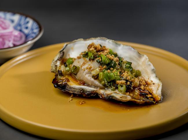 Jumbo oyster and scallion oil with roasted crushed peanuts, part of Eddy + Wolff’s share menu style of food. Picture: Jerad Williams