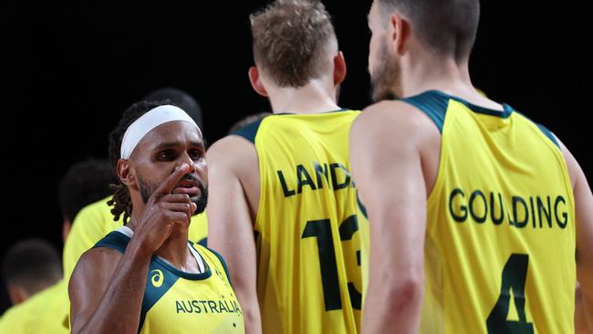 Australia's Patty Mills celebrates with teammates after their win over Germany. Picture: AFP