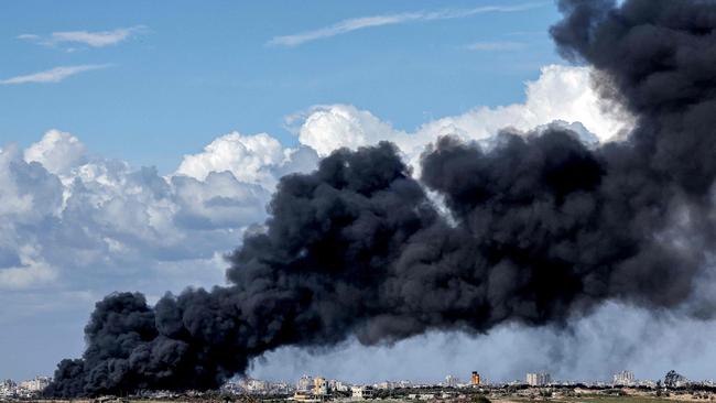 A dark smoke plume rises in the Gaza Strip during the ongoing conflict between Israel and Hamas.