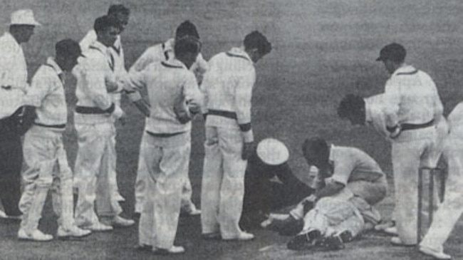 England fast bowler Frank Tyson down for the count after being knocked senseless by a bouncer from Ray Lindwall.