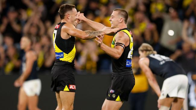 MELBOURNE, AUSTRALIA - MARCH 13: Richmond debutant Sam Lalor (R) celebrates with teammate Rhyan Mansell after the siren during the 2025 AFL Round 01 match between the Richmond Tigers and the Carlton Blues at the Melbourne Cricket Ground on March 13, 2025 in Melbourne, Australia. (Photo by Dylan Burns/AFL Photos via Getty Images)