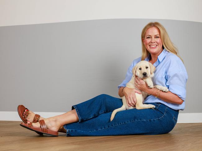 Sam Armytage with guide dog puppy Gypsy, in St Leonards on Thursday. Picture: Justin Lloyd.