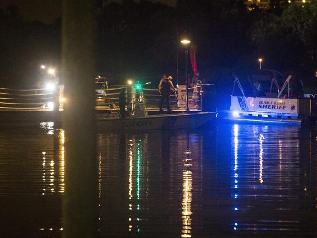 Police officers search for the child who was pulled into the water by an alligator near Disney's Grand Floridian Resort &amp; Spa in Orlando, Florida. Picture: EPA/JOHN TAGGART