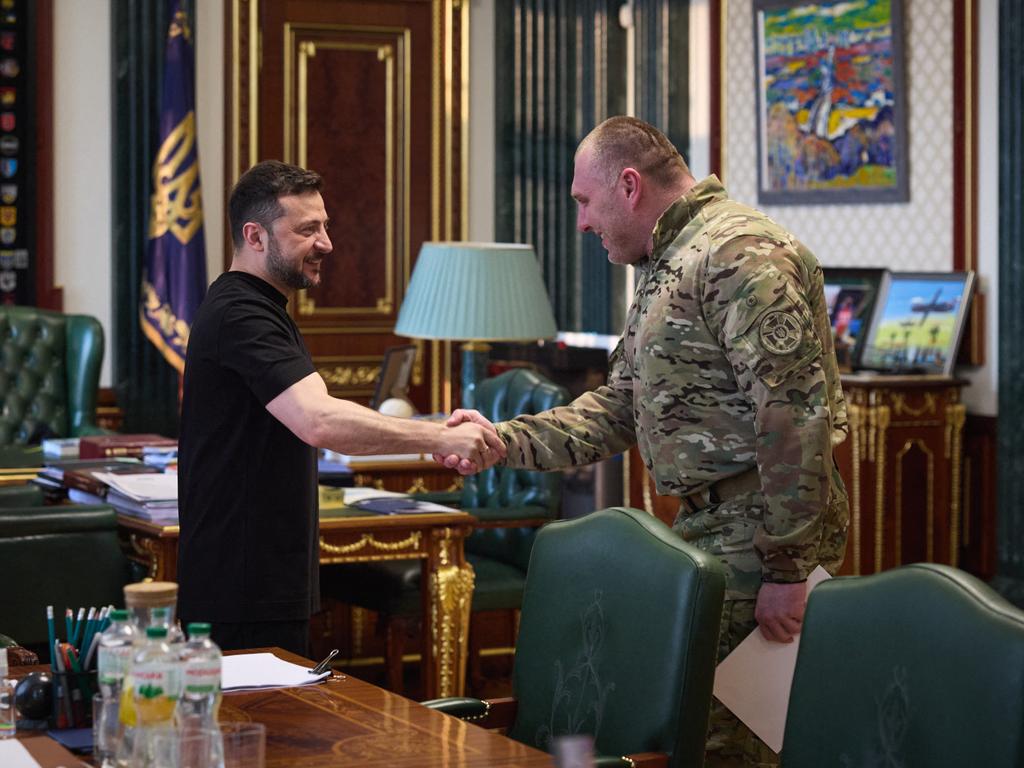 Ukrainian President Volodymyr Zelensky (L) shakes the hand of the head of Ukraine’s Security Service Vasyl Malyuk (R) in Kyiv after the 