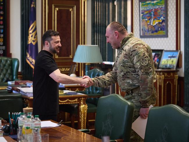 Ukrainian President Volodymyr Zelensky (L) shakes the hand of the head of Ukraine’s Security Service Vasyl Malyuk (R) in Kyiv after the 