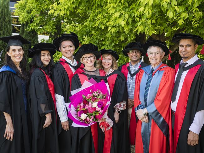 UniSQ School of Health and Medical Sciences staff (from left) Helena King, Dr Nikita Walz, Dr Lin Ong, PhD graduate Dr Leanne Dooley, Prof Eliza Whiteside, Dr Prajwal Gyawali, Prof Mike Kotiw and Dr Tarek Ahmad show their support for Dr Dooley at her graduation ceremony at Empire Theatres, Tuesday, October 31, 2023. Picture: Kevin Farmer