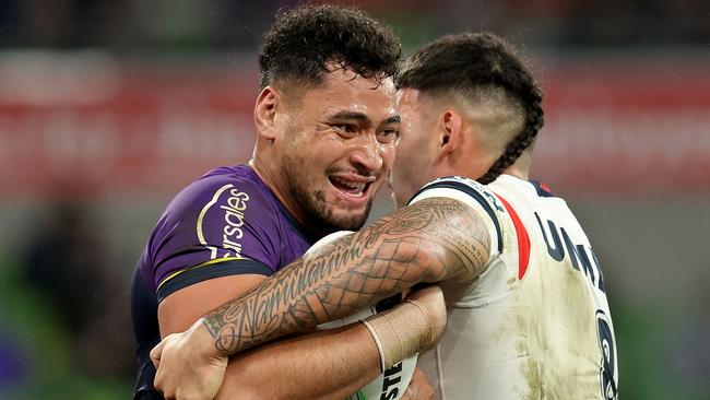 MELBOURNE, AUSTRALIA - JULY 20: Eliesa Katoa of the Storm is tackled by Terrell May of the Roosters during the round 20 NRL match between Melbourne Storm and Sydney Roosters at AAMI Park, on July 20, 2024, in Melbourne, Australia. (Photo by Kelly Defina/Getty Images)