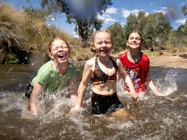 Harper, 5 (black), Maddie, 8 (green) and Nyah, 10 (red), at a waterhole Warrumbungle National Park. Picture: Liam Mendes / The Australian