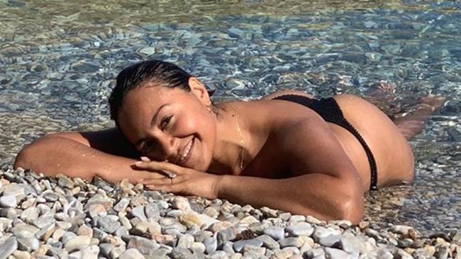 A photo of Jess Mauboy posted by her fiance, Themeli Nickolas Magripilis to his Instagram page showing Jess on a pebbled beach on the island of Kalymnos, Greece.