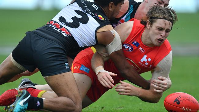 Port’s Jake Neade tackles the Suns’ Brad Scheer at Jiangwan Stadium in Shanghai, China. Picture: AAP Image/David Mariuz