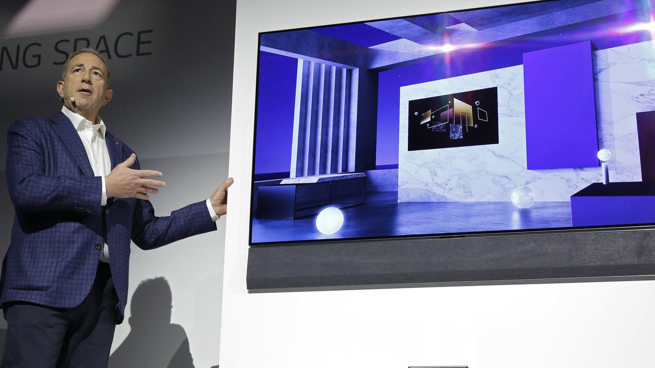 Tim Alessi, head of home entertainment product marketing for LG US, unveils a GX series OLED TV during a news conference at CES. Picture: AP Photo/John Locher.