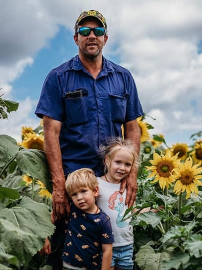 Anthony Trimarchi farmer at Tolga Sunflower Farm with his children. Picture: supplied