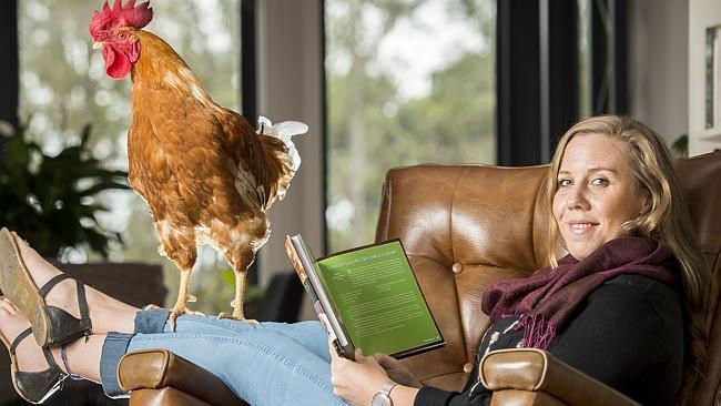 Aleisja Henry, with her rooster Honky, is passionate about changing people's ideas about chickens which she says make affectionate and loving pets. Picture: Jason Edwards