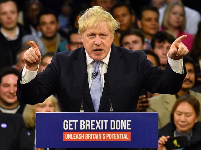 (FILES) In this file photo taken on December 11, 2019 Britain's Prime Minister and Conservative party leader Boris Johnson speaks during a general election campaign rally in East London on December 11, 2019, the final day of campaigning for the general election. - The former London mayor was a figurehead in the official Leave campaign, urging Britain to "take back control" from Brussels, where he was once an EU-bashing political correspondent. Boris Johnson was then made foreign secretary by Theresa May, but his two-year stint ended when he resigned over her Brexit strategy. Johnson retained a high profile, using his weekly column in The Daily Telegraph to attack her approach, and was well-placed to take advantage when May eventually stood down. Scoring a thumping majority in 2019's general election he went on to secure a post-Brexit trade deal with the EU but his promises of a trans-Atlantic pact by the end of the year fell by the wayside. (Photo by Ben STANSALL / AFP) / TO GO WITH AFP STORY BY JOE JACKSON