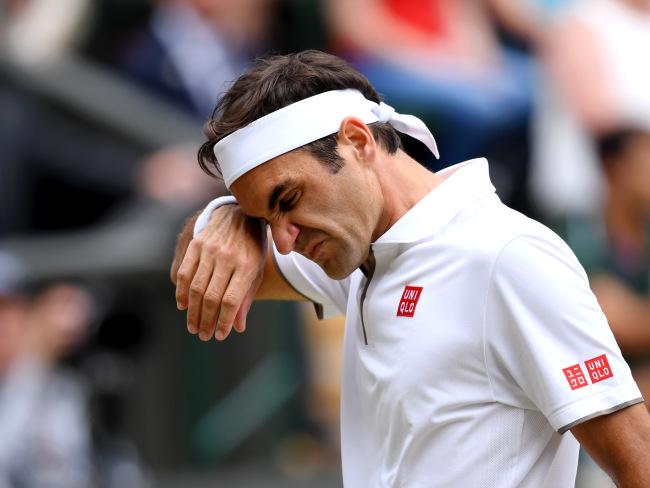 Roger Federer wipes sweat from his brow during the five-hour epic.