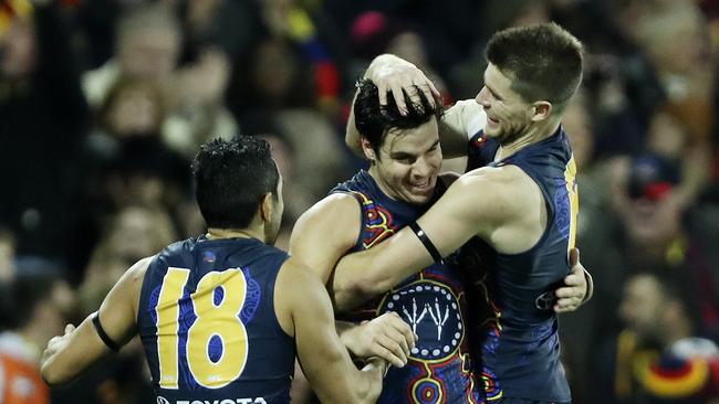 Eddie Betts and Bryce Gibbs congratulate Darcy Fogarty on his big last quarter goal. Picture: Sarah Reed