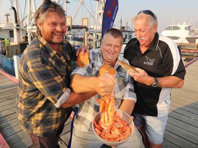 HOLD FOR HERALD SUN PIC DESK----East Gippsland tourism in fire affected areas, in attempts to draw the crowds back to seaside locations and small country towns. Lakes Entrance fisherman Darryl Fulton, Buzz Butcher and Kevin Rowe with their catch from their trawler names 'The Nina'  Picture: Alex Coppel.