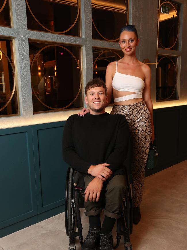 Otten with partner and paralympian Dylan Alcott. Picture: Lucas Dawson