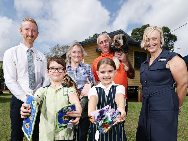 Freshwater Christian College principal Matt Scott, Grade 3 student Callon Bryant, Grade 4 student Aria Garvellotto and head of junior school Jane Greenlees with organisers Sue Tons from the QCWA Freshwater branch and Kane Brown, pictured with his dog Lyla. Picture: Brendan Radke