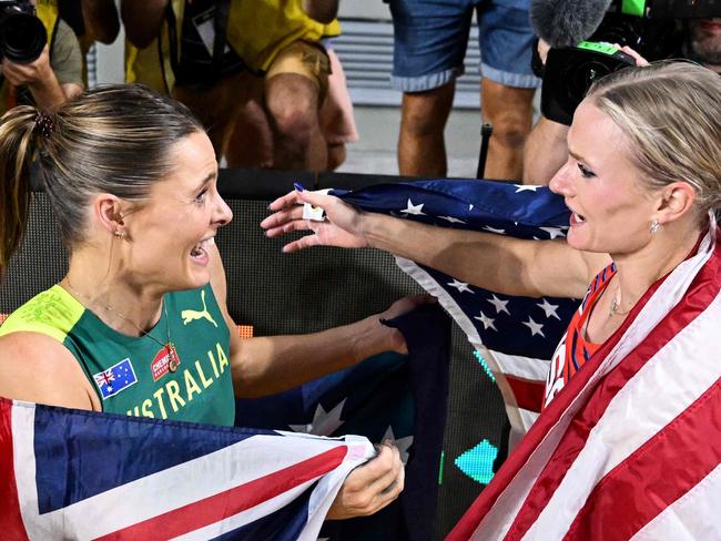 First-placed Australia's Nina Kennedy (L) celebrates with USA's Katie Moon (R) as they decide to share the gold medal after recording the same height in the women's pole vault final during the World Athletics Championships at the National Athletics Centre in Budapest on August 23, 2023. (Photo by Kirill KUDRYAVTSEV / AFP)