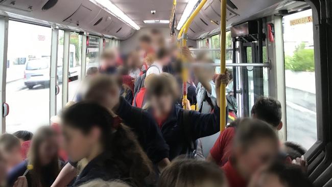 Students fill every available spot on this bus as they head to school.