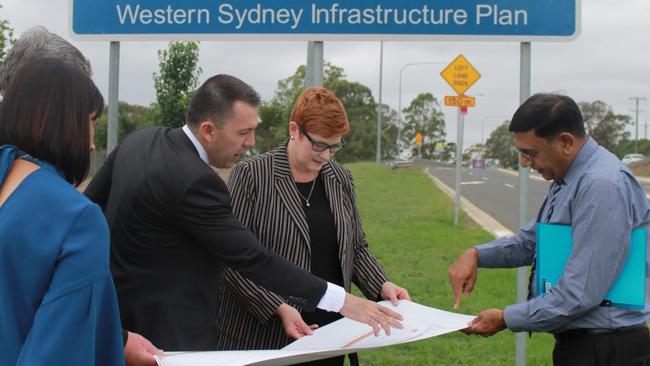 Liberal Senator for Western Sydney Marise Payne and Campbelltown Mayor George Brticevic discuss plans for the upgrade to Badgally Rd at an onsite meeting in December.