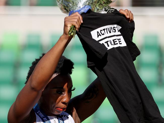 Gwen Berry raised her “Activist Athlete” T-shirt during the National Anthem at the US Olympic trials. (Photo by Patrick Smith/Getty Images)