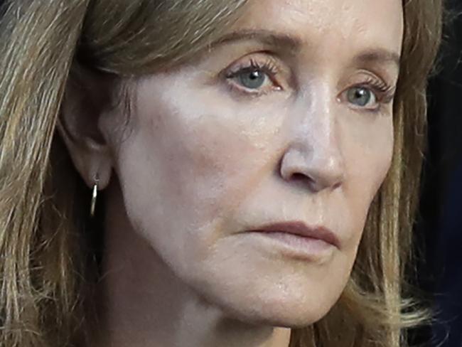 FILE - This Sept. 13, 2019 file photo shows actress Felicity Huffman leaving federal court after her sentencing in a nationwide college admissions bribery scandal in Boston. A representative for Huffman says she reported to a federal prison in California to serve a two-week sentence on Tuesday, Oct. 15. Last month a federal judge in Boston sentenced Huffman to 14 days in prison, a $30,000 fine, 250 hours of community service and a year's probation after she pleaded guilty to fraud conspiracy for paying an admissions consultant $15,000 to have a proctor correct her daughter's SAT answers. (AP Photo/Elise Amendola, File)