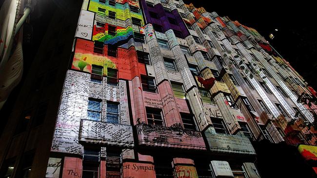 Images are projected onto the Lindt Cafe building during a ceremony to commemorate the first anniversary of the Lindt Cafe siege at Martin Place in 2015. Picture: AAP