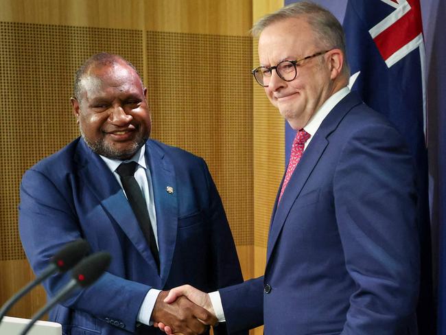 Australian Prime Minister Anthony Albanese (R) shakes hands with Papua New Guinea's Prime Minister James Marape during a press conference in Sydney on December 12, 2024. (Photo by DAVID GRAY / AFP)