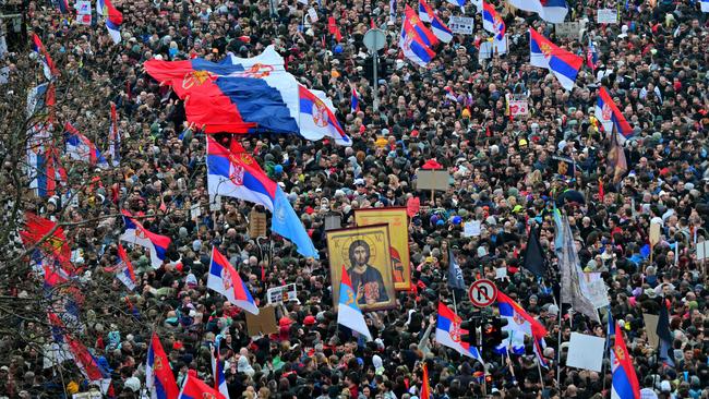 Protesters held up the national flag and Christian icons. Picture: Andrej Isakovic/AFP