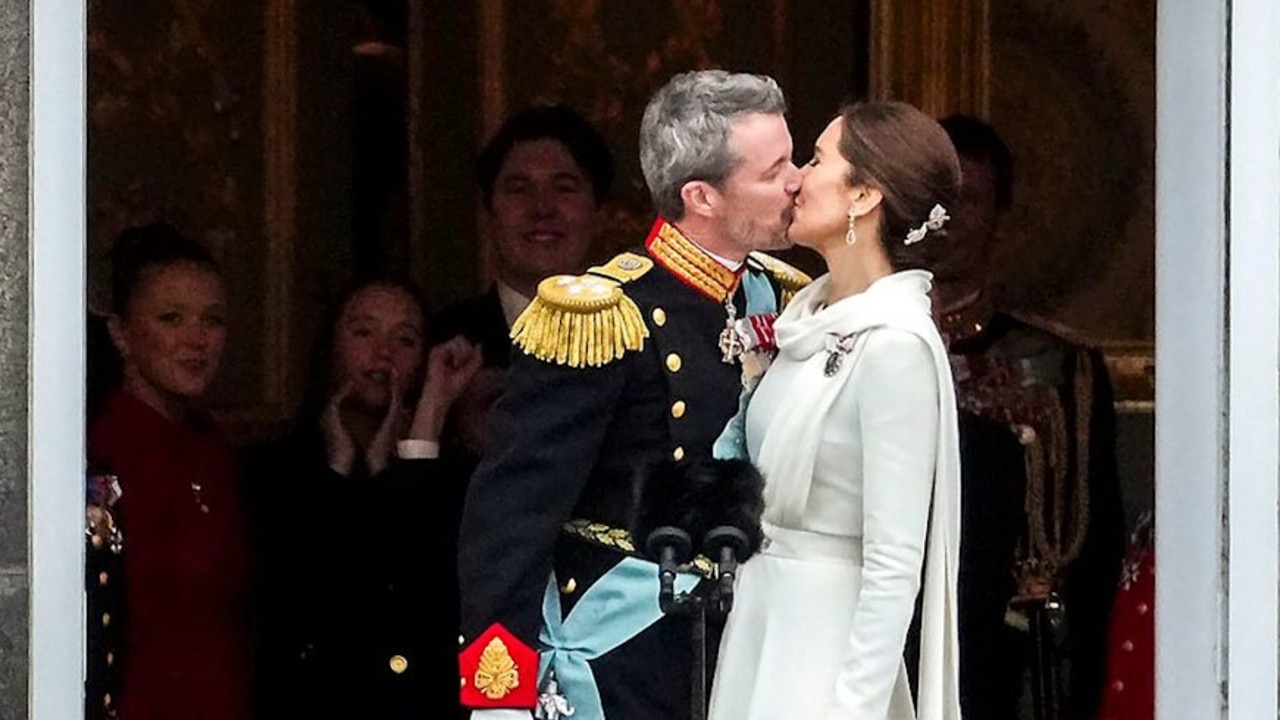 Prince Joachim can been seen behind Mary as she kisses Frederik on the balcony after becoming King and Queen. Picture: Ida Marie Odgaard / Ritzau Scanpix / AFP