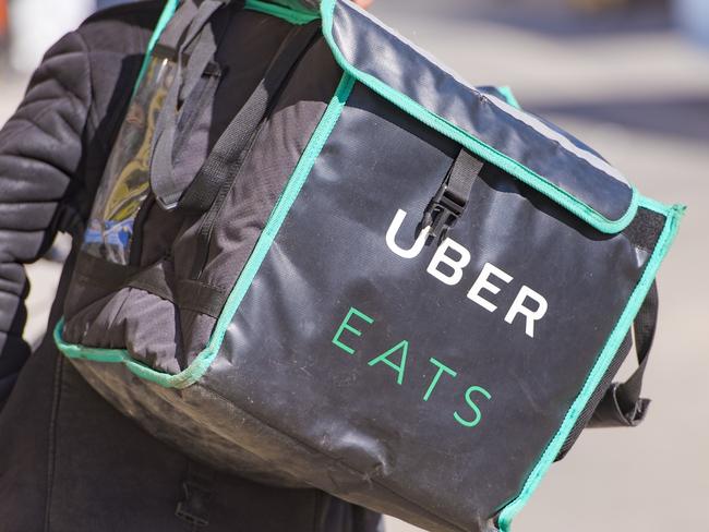 MOSCOW - APR 23: Worker with Uber Eats bicycle and a bag in a street of Moscow on April 23. 2018 in Russia