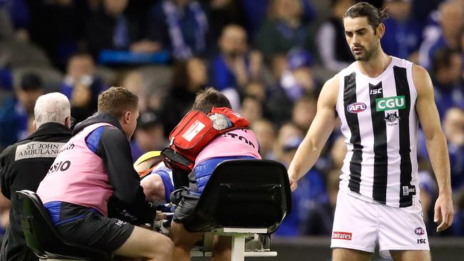 Grundy checks on Brown as he’s stretchered off. Picture: Getty Images