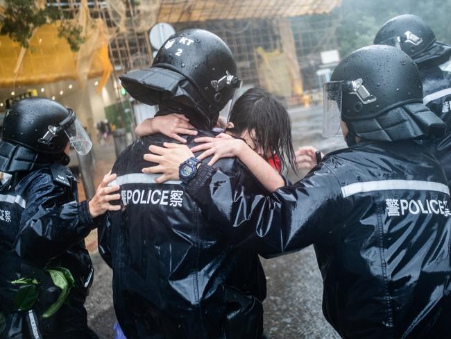 Police officers carry a girl out of a collapsed school in Hong Kong. Picture: Getty