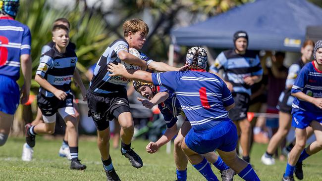 Day One of King of the Country rugby tournament at James Overell Park, Southport. Maroochydore Swans U14s' Brock Coombes in against USQ Saints U14s (blue white small stripes). Picture: Jerad Williams