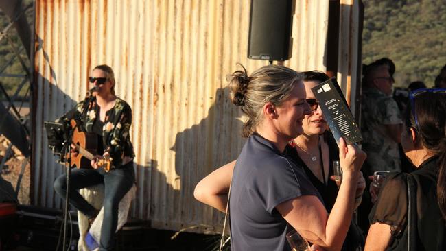 Musician Katie Harder greeted arrivals upon entry at the Old Quarry in Alice Springs. Picture: Gera Kazakov