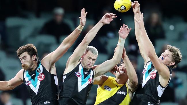 Scott Lycett, Peter Ladhams and Mitch Georgiades fly high against Richmond's Ivan Soldo.