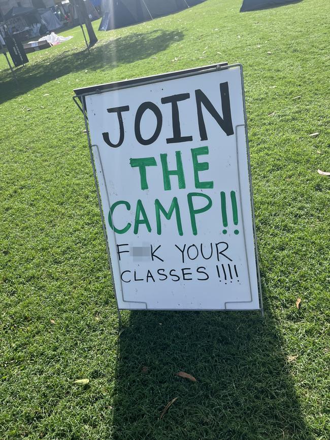 Protest signs at the pro-Palestinian encampment at the University of Queensland. Photo: Natasha Bita