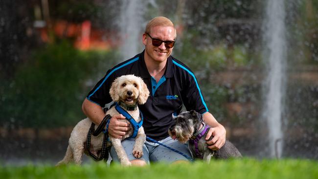 Darwin RSPCA chair Danny Moore and his pooches Molly and Buddy are looking forward to the Million Paws Walk. Picture: Che Chorley