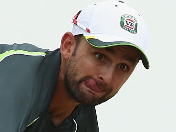 ROSEAU, DOMINICA - MAY 31: Nathan Lyon of Australia bowls as Fawad Ahmed of Australia looks on during an Australian nets session at Windsor Park on May 31, 2015 in Roseau, Dominica. (Photo by Ryan Pierse/Getty Images)