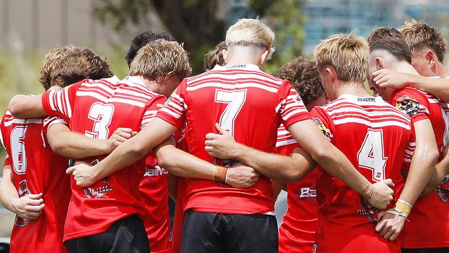 The Illawarra South Coast Dragons huddle together. Picture: John Appleyard