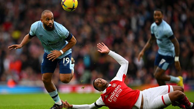 Brentford’s Bryan Mbeumo battles for possession as Gabriel takes a tumble. Picture: Getty