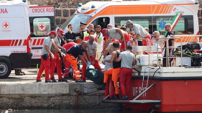 Rescuers bring a body bag back to shore after the super yacht sunk. Picture: Twitter/X